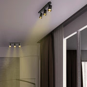 Astra Pearl Grey Cylinder GU10 Spotlight illuminating a modern living room with minimalist decor, enhancing the stylish ambiance.172-030393
