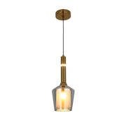 A stylish, modern pendant light. Gold metal fixtures with a clear, smoky glass shade.