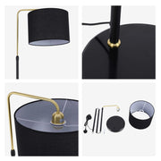A black floor lamp with a brass arm and a black drum shade. It has a sleek, modern design perfect for adding ambient light to any space.