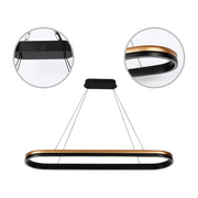 Modern LED chandelier with a black and gold finish. Suspended by thin wires from a rectangular ceiling mount.