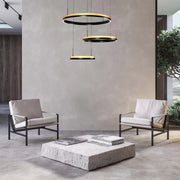 Contemporary room with stylish, circular pendant lights in black and wood finish, suspended above a stone coffee table.