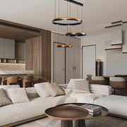 Stylish lighting fixtures hang above a modern living space. Statement pendant lighting adds a touch of luxury.