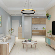 Contemporary room lighting with a unique ring-shaped pendant light, plus a classic desk lamp. Plenty of natural light floods the space.