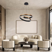 A modern ringed light fitting hangs over a cream lounge set in an elegant living room. The light is black and gold.