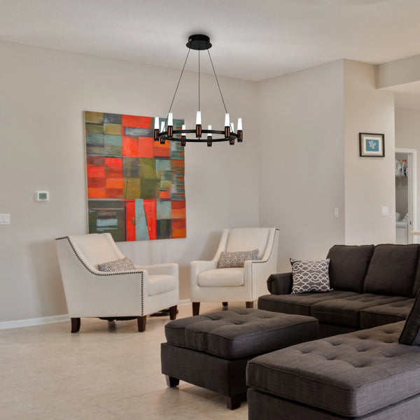 A modern chandelier with a circular design, featuring sleek black metal and cylindrical white shades, illuminates this stylish living room.