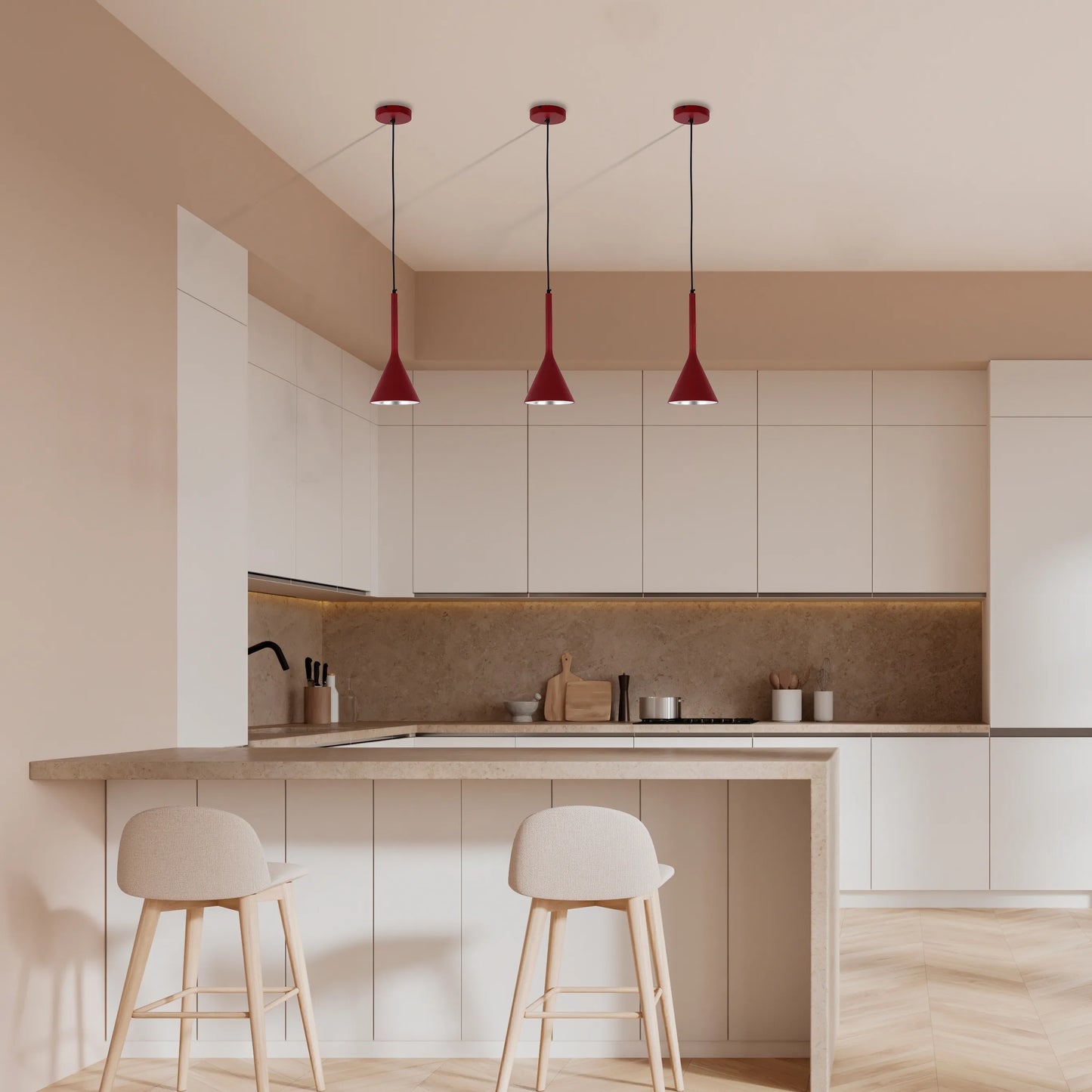 Three red pendant lights hang above a kitchen island. Modern design for stylish kitchen lighting.