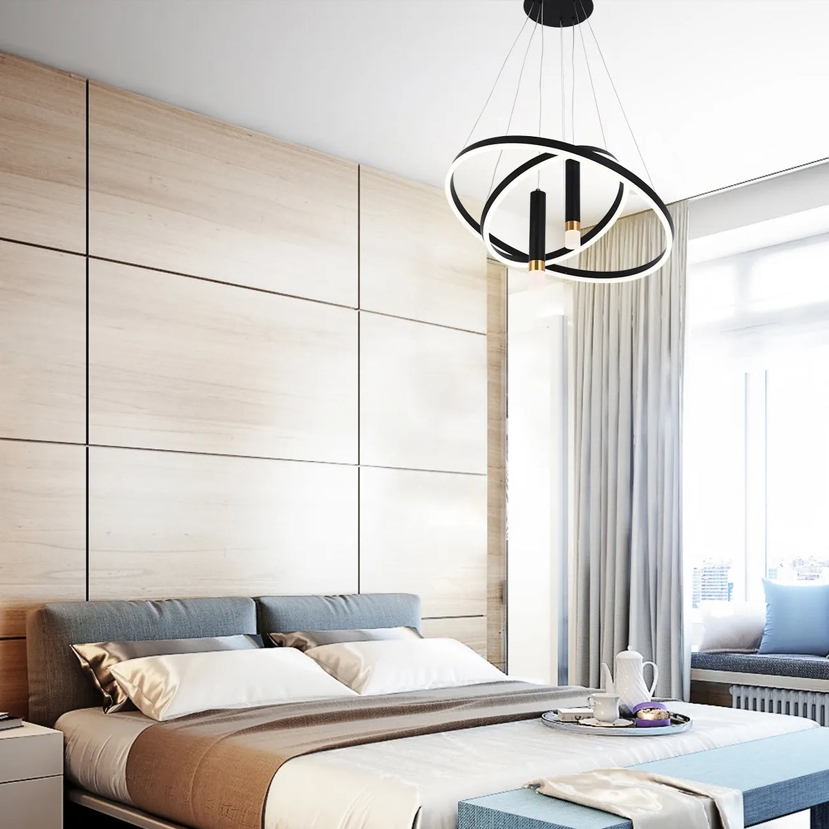 A modern black and white chandelier hangs above a bed in this bright bedroom. Circular rings and cylindrical lights feature.