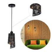 A black geometric pendant light with a cut-out design, showcased in a modern interior with wood panelling.