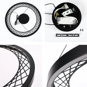 Modern black circular LED pendant light with a geometric design, showing the light's components and fixings.