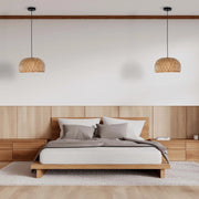 Bedroom with two woven pendant lights hanging above matching wooden bedside tables and a bed with a headboard.
