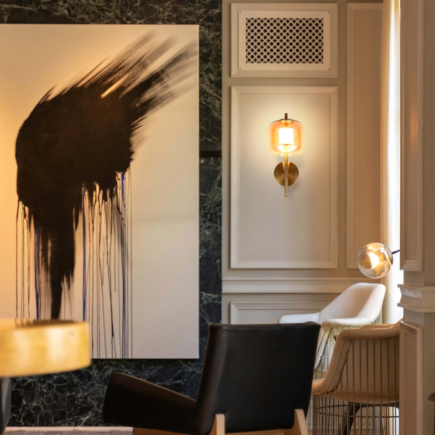 Stylish lighting fixtures on display, including a modern sconce and a globe pendant lamp. Contemporary interior lighting design.
