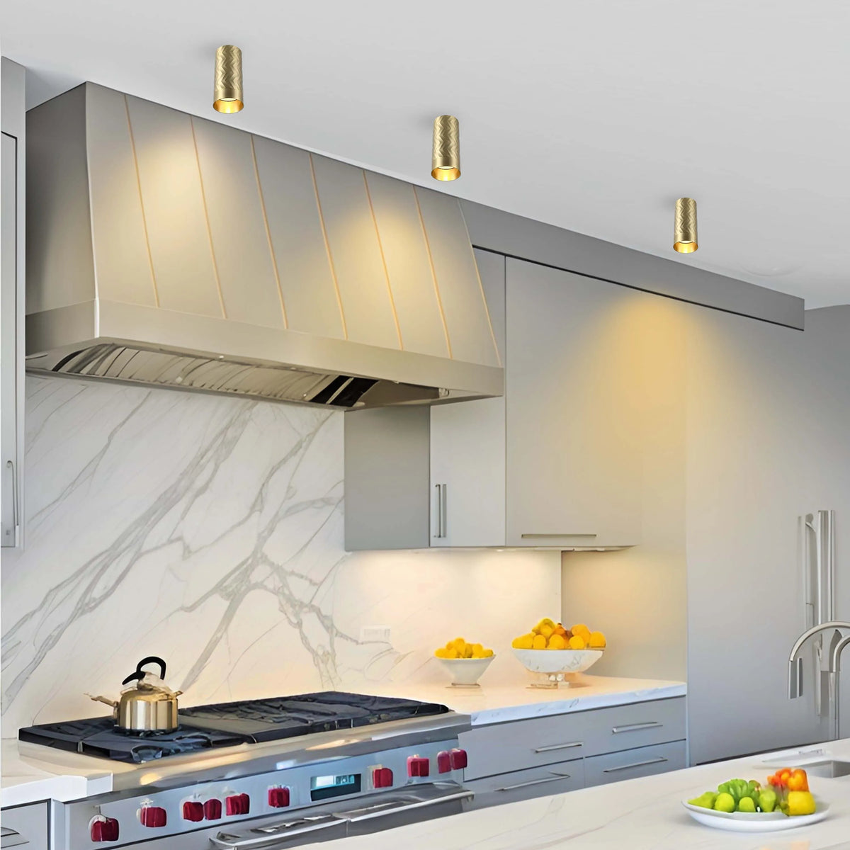 Contemporary kitchen with gold-coloured cylinder spotlights on the ceiling providing focused downlighting to illuminate the room.