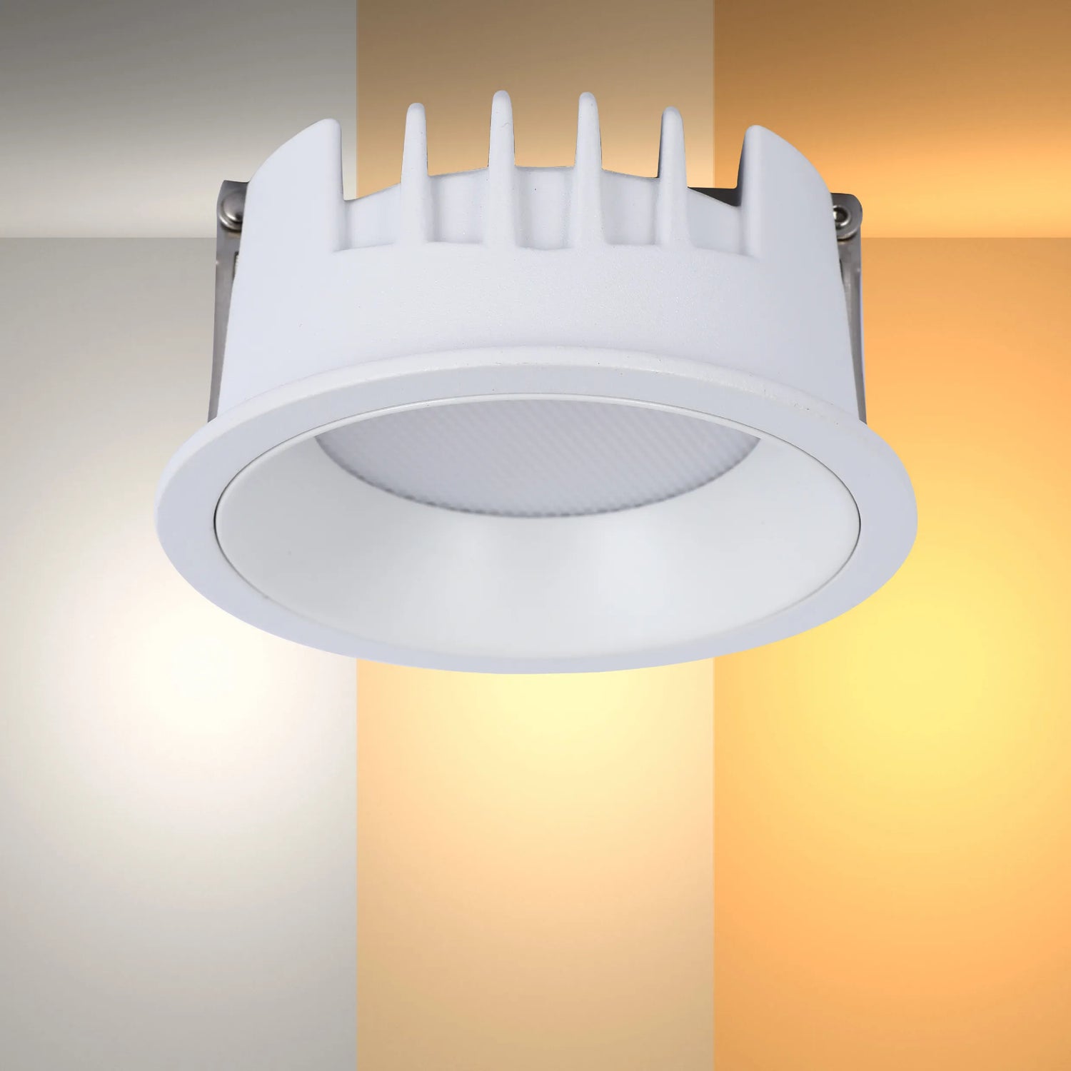 A recessed downlight illuminating various warm colour temperatures, highlighting its adaptability.