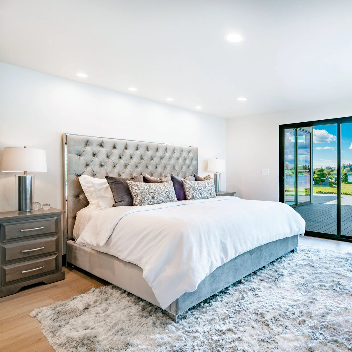 Bright bedroom with ample downlighting and lamps. A well-lit space showcasing modern lighting for a luxurious feel.