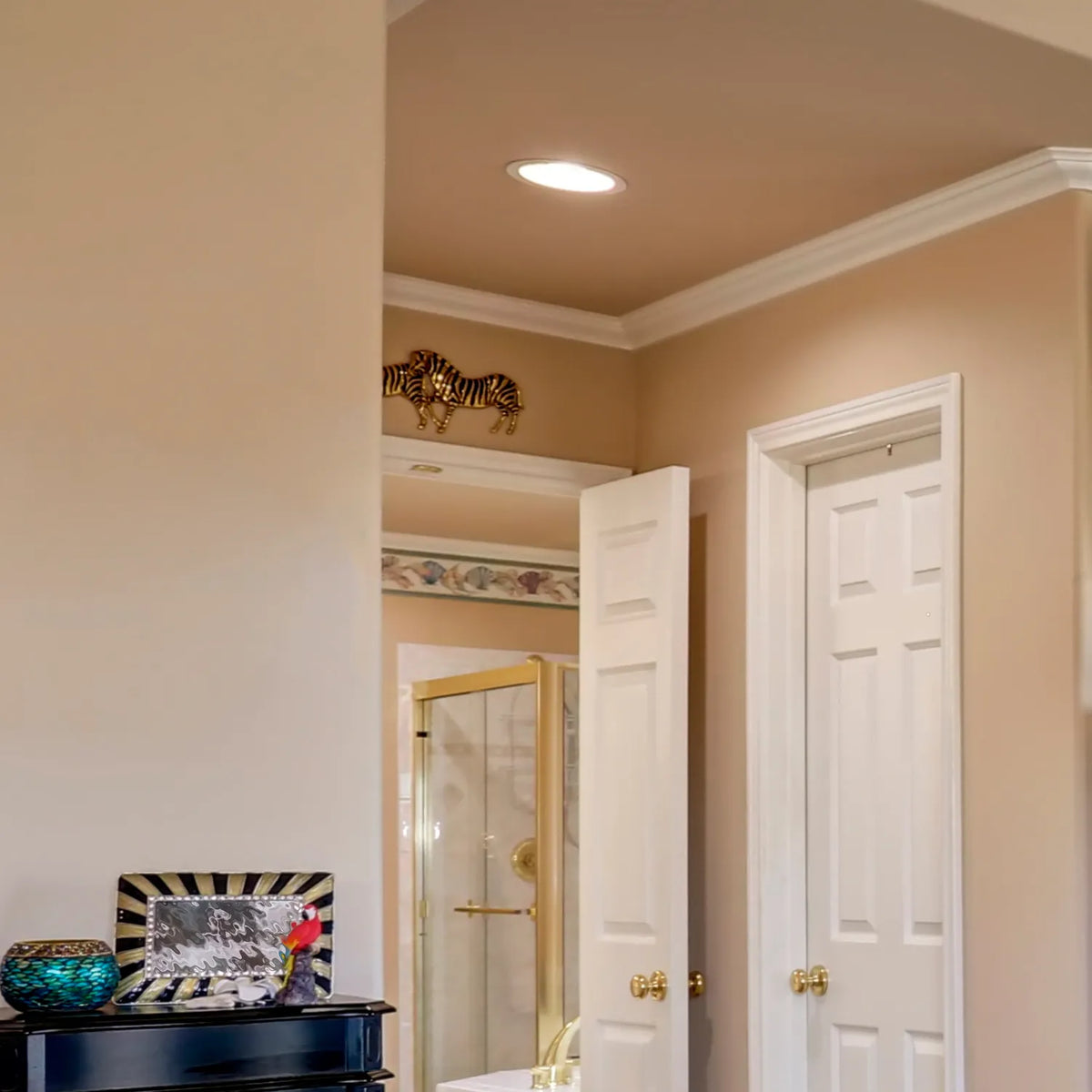 A recessed ceiling light provides general illumination, enhancing the room's warm, neutral colour scheme.