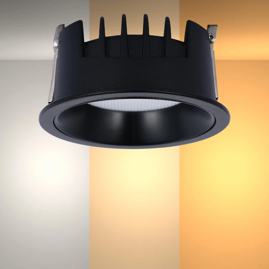 A black recessed downlight sits against a gradient background displaying the colour temperature changing from cool white to warm white.