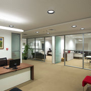 The office has a combination of recessed and linear lighting, creating a bright, functional and modern atmosphere.