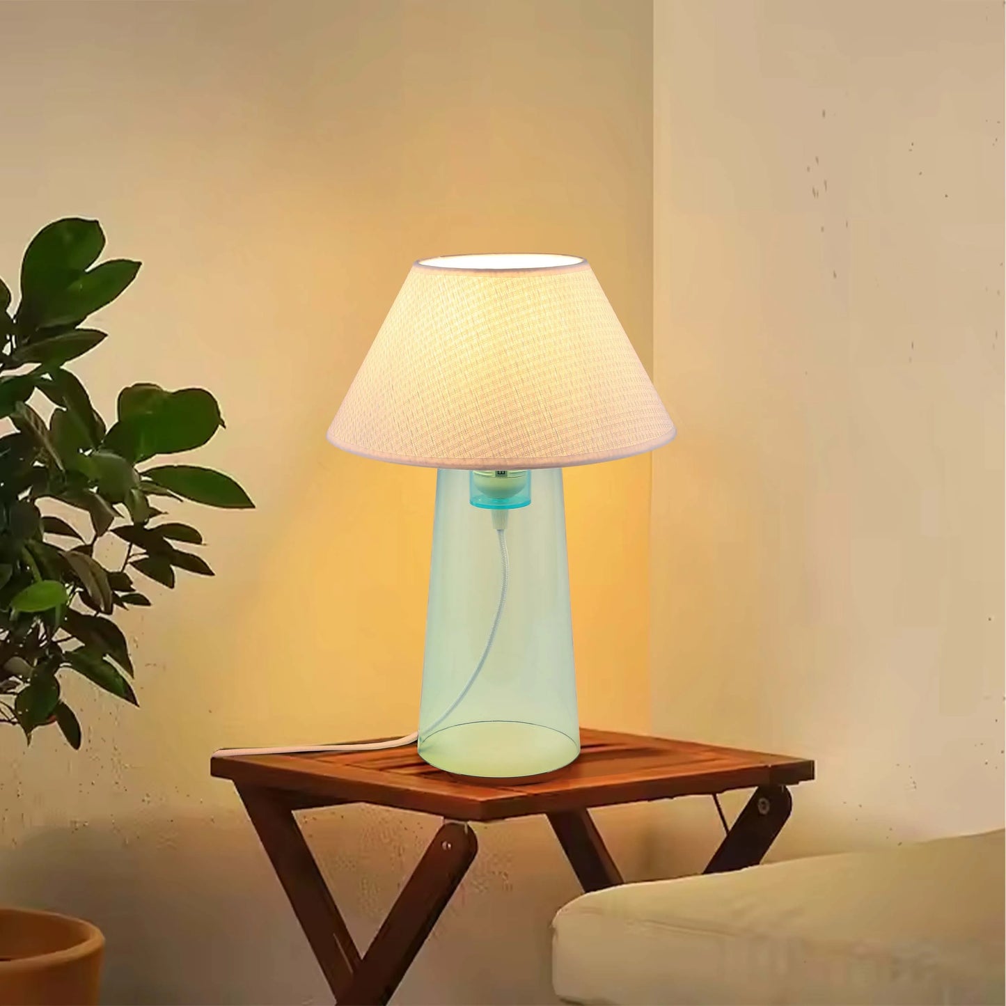 Illuminated table lamp with a pale lampshade and a light blue base, creating a warm and inviting ambience.