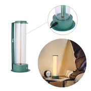 A trendy LED lamp, with a clear tube design, illuminates in a warm, inviting light, perfect for modern bedrooms.