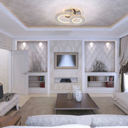Elegant room with recessed lighting highlighting quilted panels, complemented by a statement multi-ring crystal ceiling light.