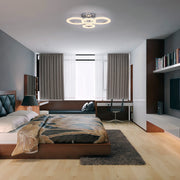 A modern bedroom features a circular LED ceiling light, adding a contemporary touch to the space.