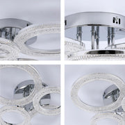 A modern chrome flush mount ceiling light featuring crystal rings, adding a touch of glamour to any room.