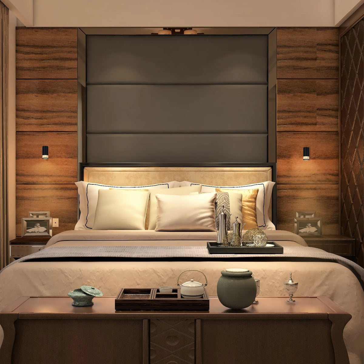 Ambient lighting creates a cosy bedroom atmosphere. Wall sconces flank a large, padded headboard, providing a warm glow either side.