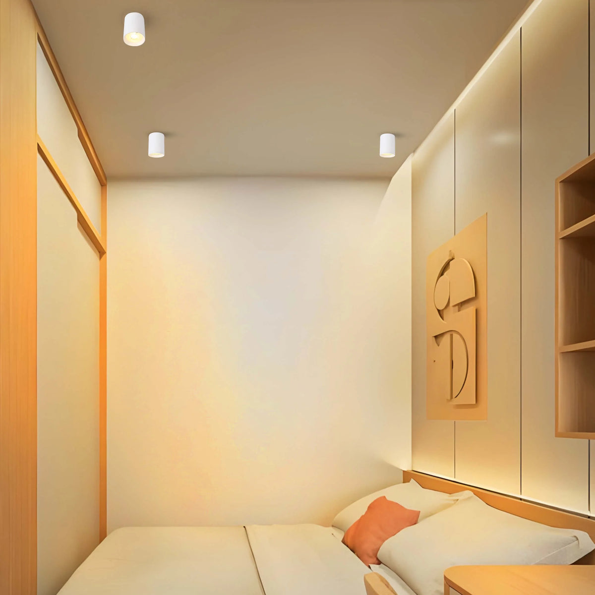Modern bedroom ceiling lights: three simple, cylindrical fixtures provide ample, evenly distributed illumination.