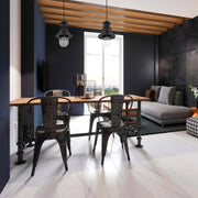 Industrial-style pendant lights hang above a rustic dining table, offering a warm and inviting atmosphere.