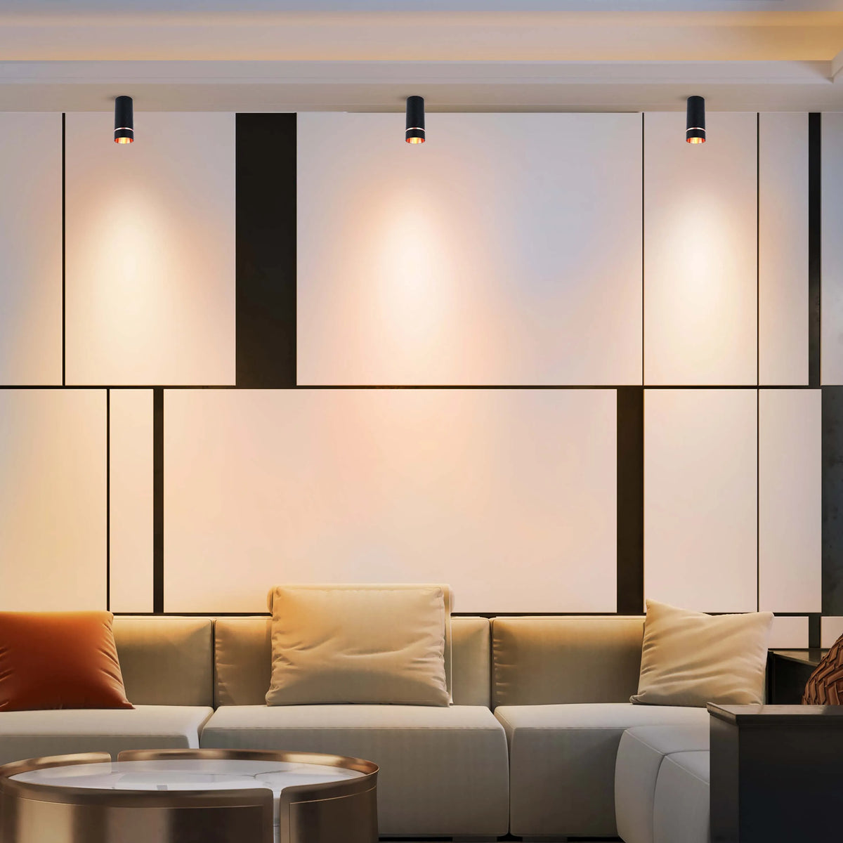 Modern spotlights illuminate a stylish feature wall with sleek panelling, complemented by soft, ambient light in a contemporary living space.