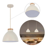 A cream pendant light with a wooden accent piece, suspended above a dining table in a modern kitchen.