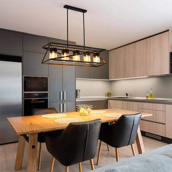 A modern, black pendant light hangs over a wooden dining table. The fixture has multiple glass shades and warm, ambient lighting.