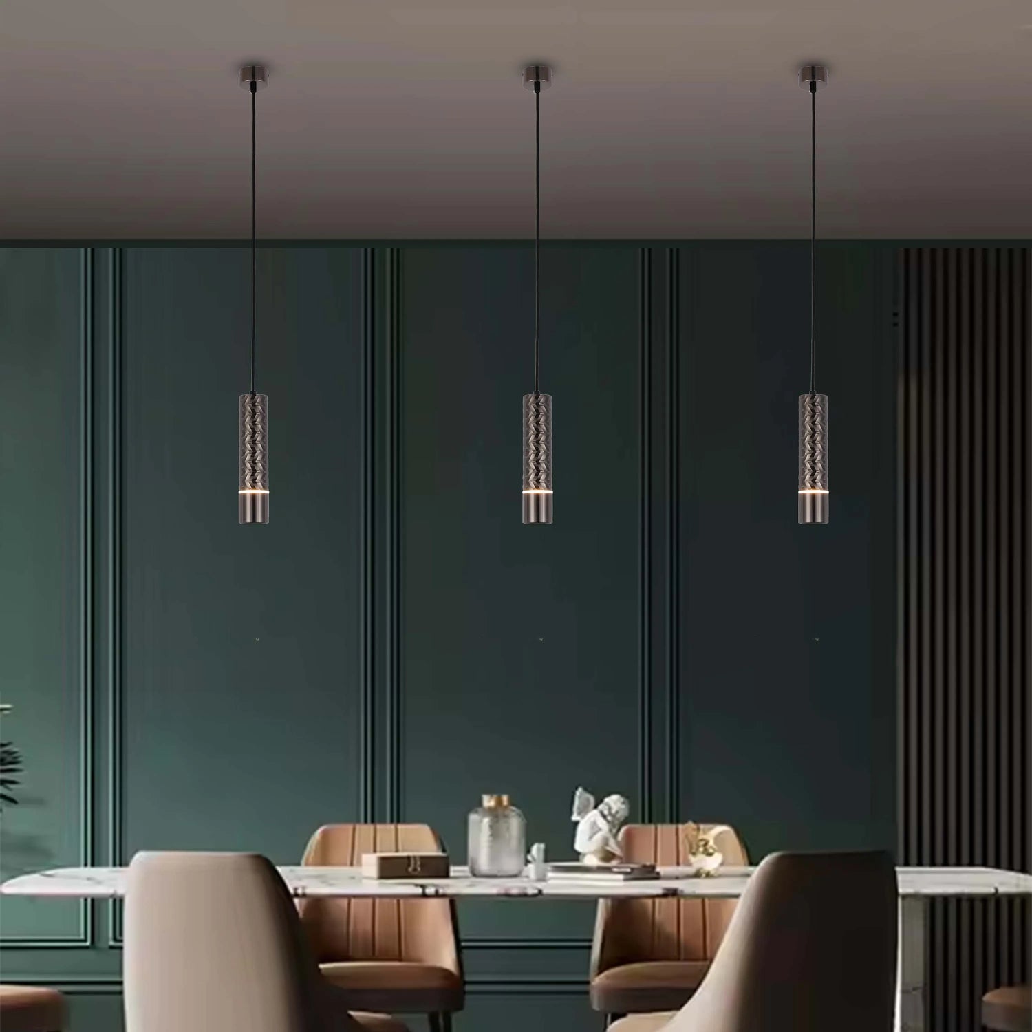 Three pendant lights hang above a dining table, casting a warm glow. Each lamp has a textured, cylindrical shade.