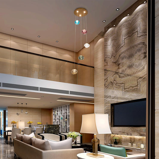 A modern living room featuring a cluster of pendant lights with colourful glass shades, and soft recessed lighting.