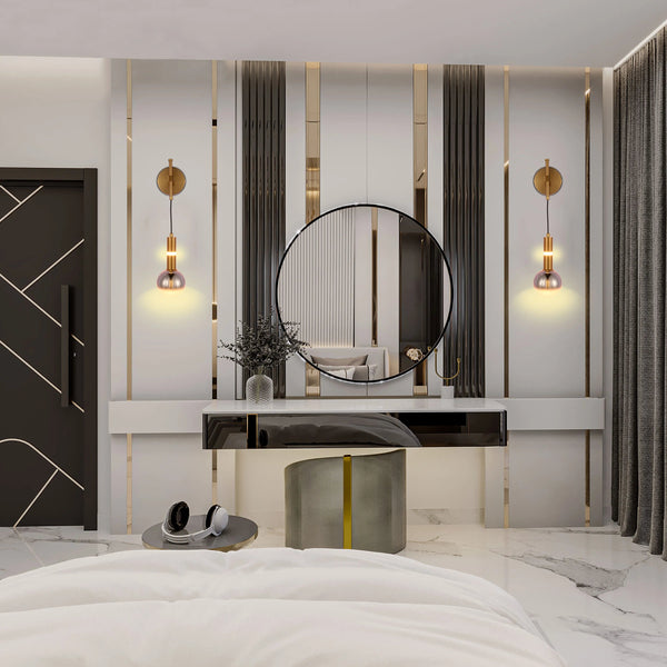 Stunning vanity lighting with gold sconces and delicate glass shades, casting a warm glow. Perfect for a stylish bedroom.
