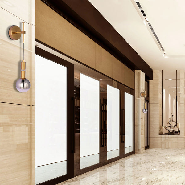 Modern wall lights with a spherical glass shade and gold finish, mounted in a luxurious corridor.