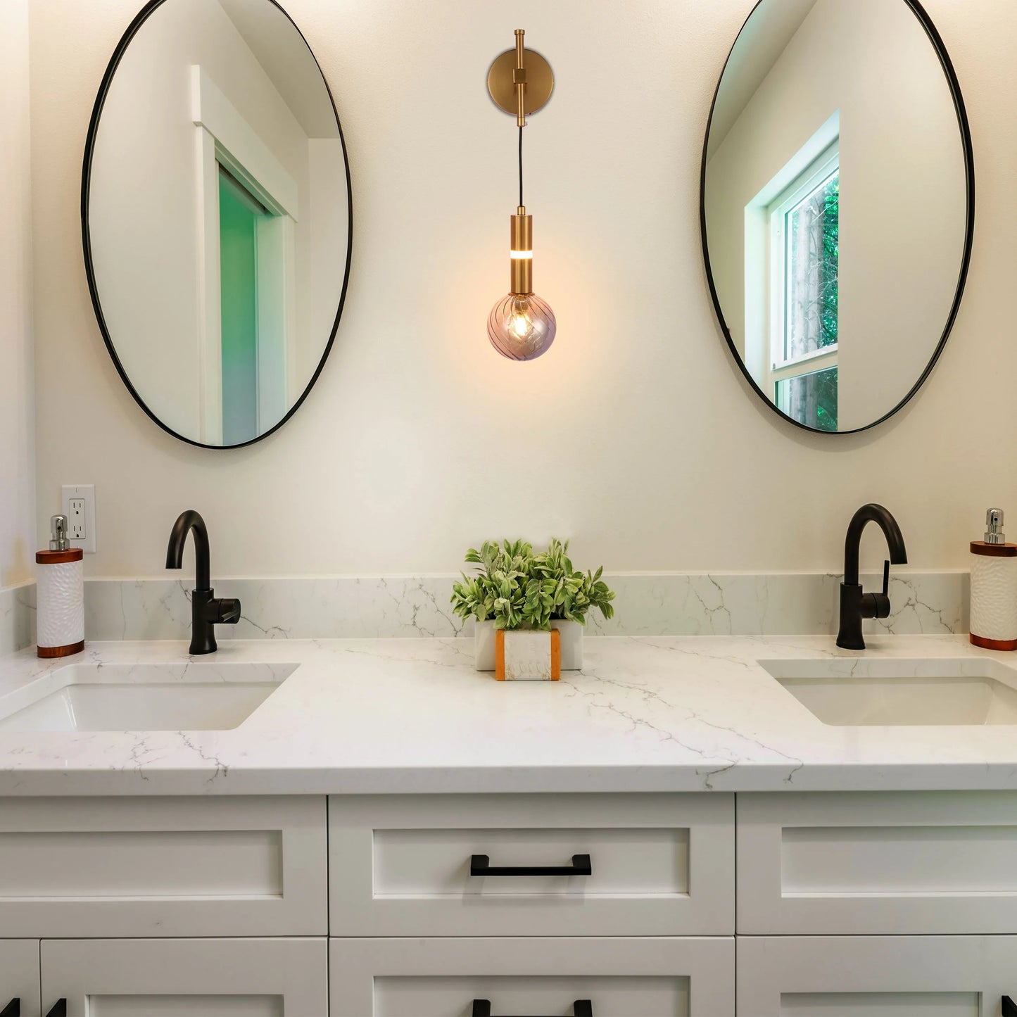 A stylish bathroom with a unique pendant light, flanked by circular mirrors, enhancing the bright, modern aesthetic.