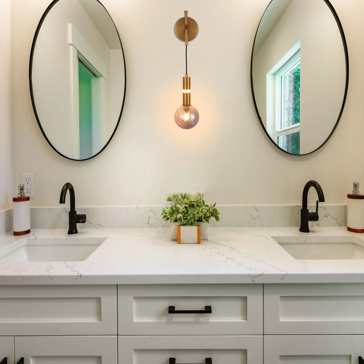 A stylish bathroom with a unique pendant light, flanked by circular mirrors, enhancing the bright, modern aesthetic.