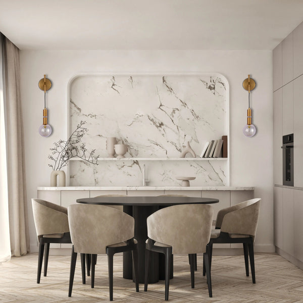 Stylish wall sconces illuminate this elegant dining space. Gold fittings hold glass globes, casting a soft, ambient light.