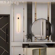 Elegant interior lighting: a modern chandelier, sleek wall sconce, and reflective mirror, adding a touch of luxury and brightness to the space.