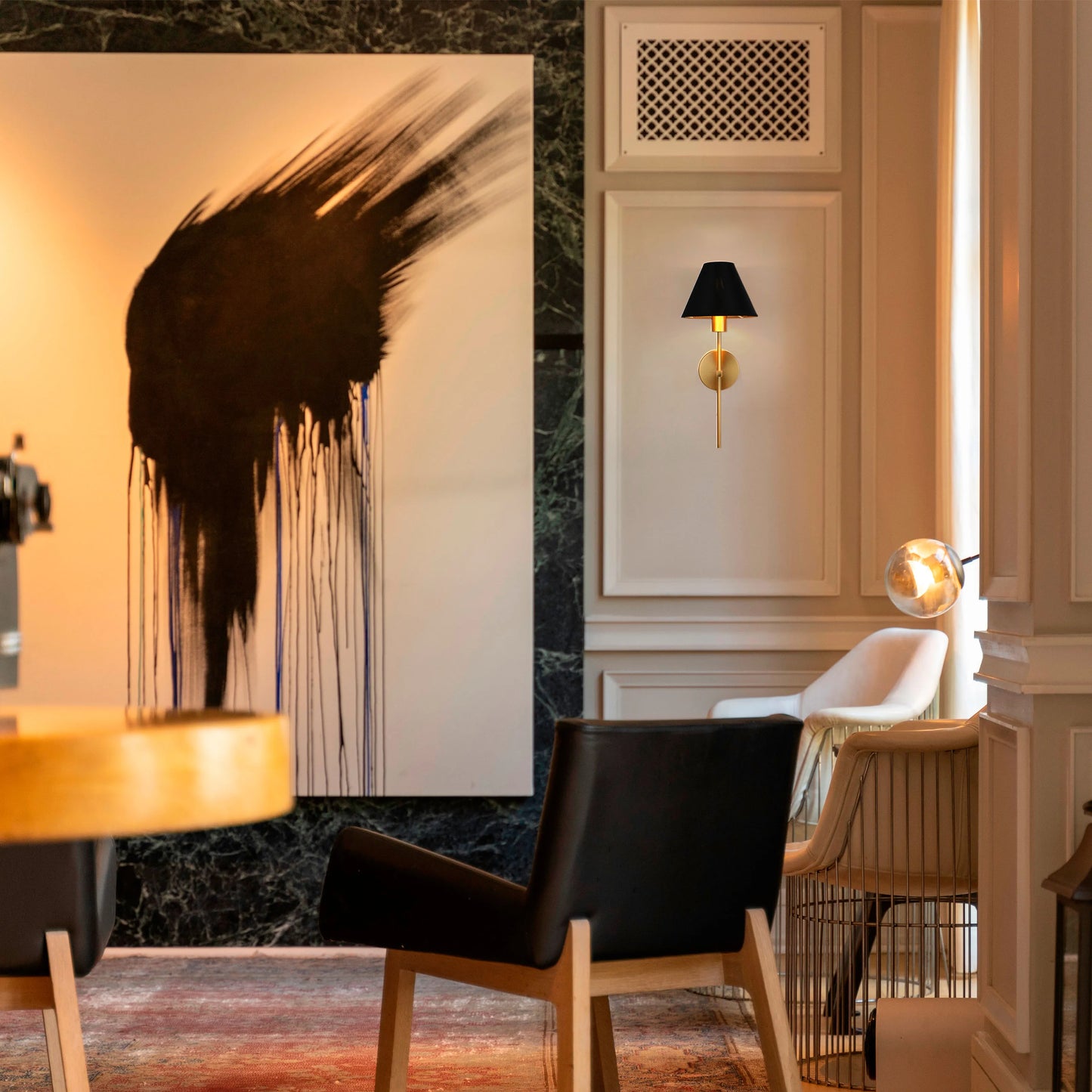 A stylish space with a statement wall light, complemented by a modern table lamp, creating a warm and inviting atmosphere.