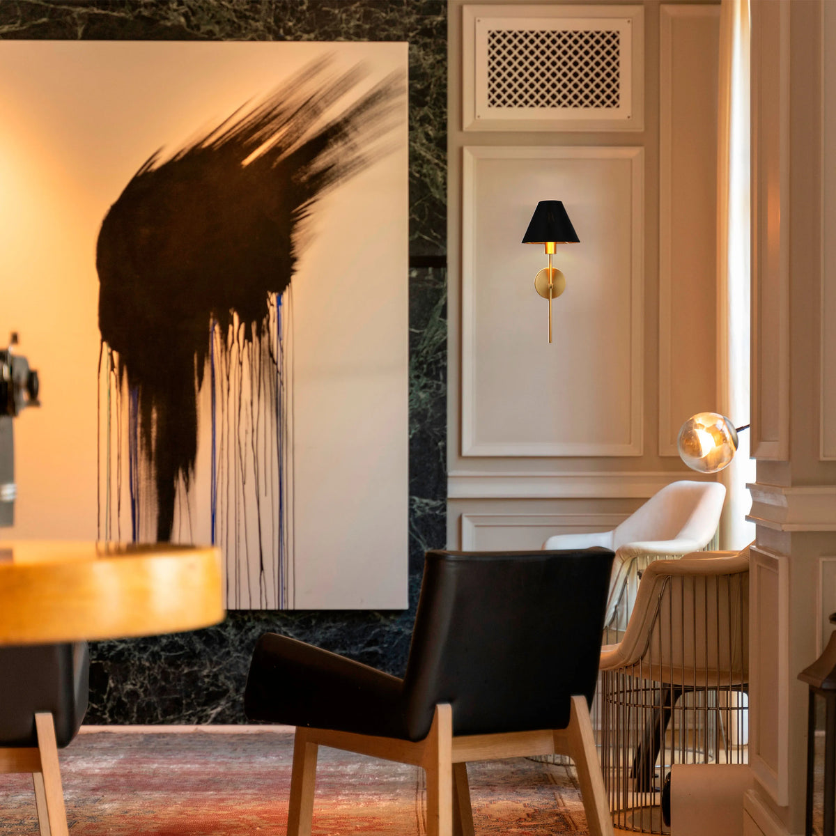 A stylish space with a statement wall light, complemented by a modern table lamp, creating a warm and inviting atmosphere.