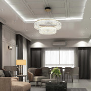 An opulent chandelier and wall sconce provide layered illumination in this elegantly decorated living space.