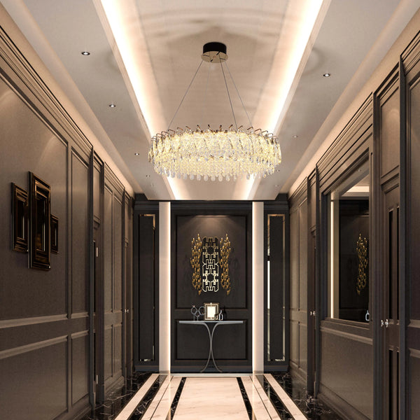 A stunning, modern chandelier illuminates this hallway, enhanced by recessed ceiling spotlights and feature wall lighting.