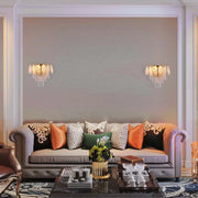 Elegant wall sconces adorn a stylish living room. The fixtures feature crystals that add a touch of glamour and sophistication.