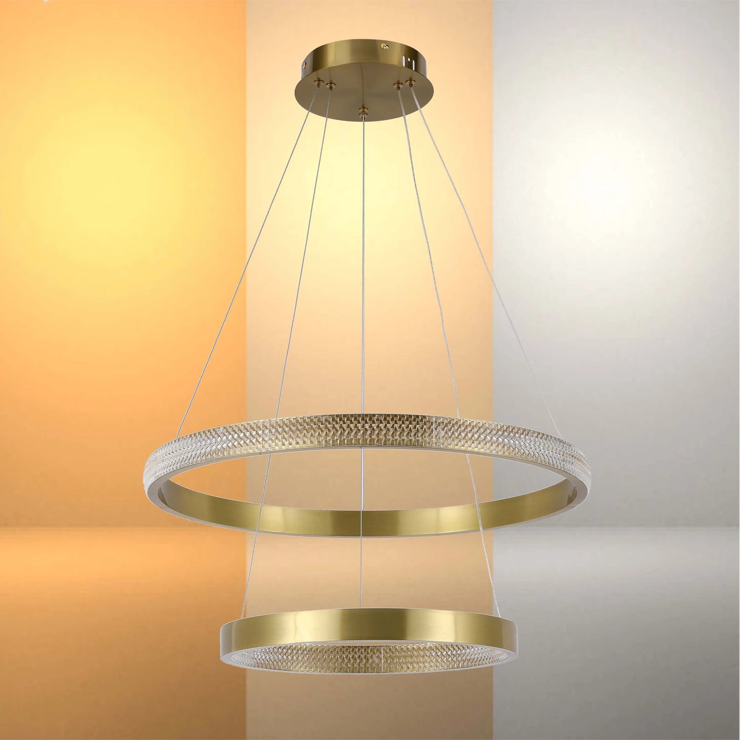 Gold ring chandelier. Two horizontal gold rings suspended with clear cables. Modern and elegant lighting design.