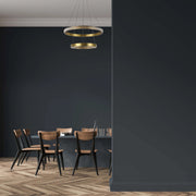Contemporary gold ring pendant light, suspended above a dining table in a modern dining room.