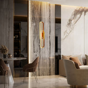 Statement lighting feature against a marble wall with warm, ambient glow, enhancing the room's luxurious feel.