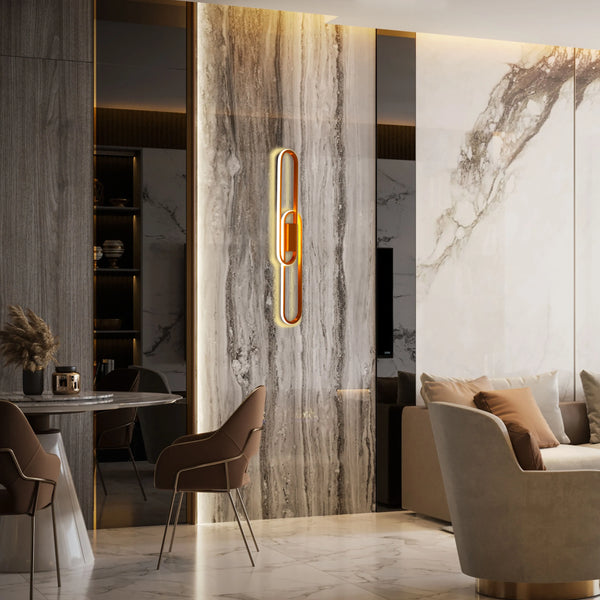 Statement lighting feature against a marble wall with warm, ambient glow, enhancing the room's luxurious feel.