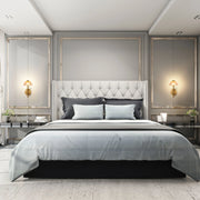 Bedroom with sconces flanking the bed. Overhead spotlights provide extra light in the room.